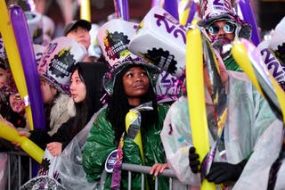 Seorang yang bersuka ria menyaksikan orang-orang merayakan Malam Tahun Baru di Times Square pada 31 Desember 2024 di New York City.